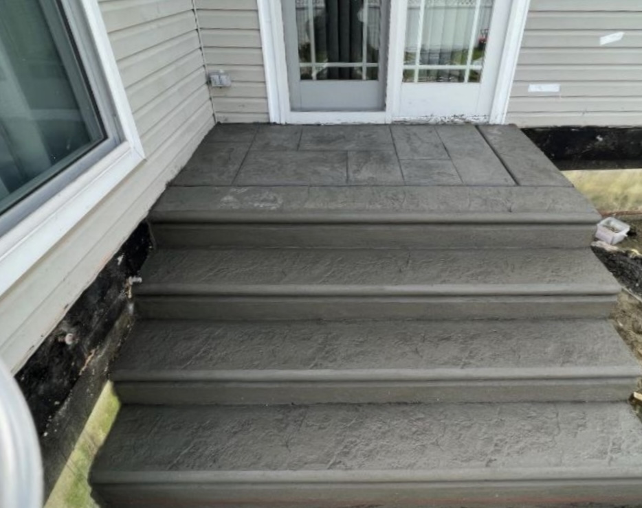 Stamped concrete steps and landing at a residential entrance