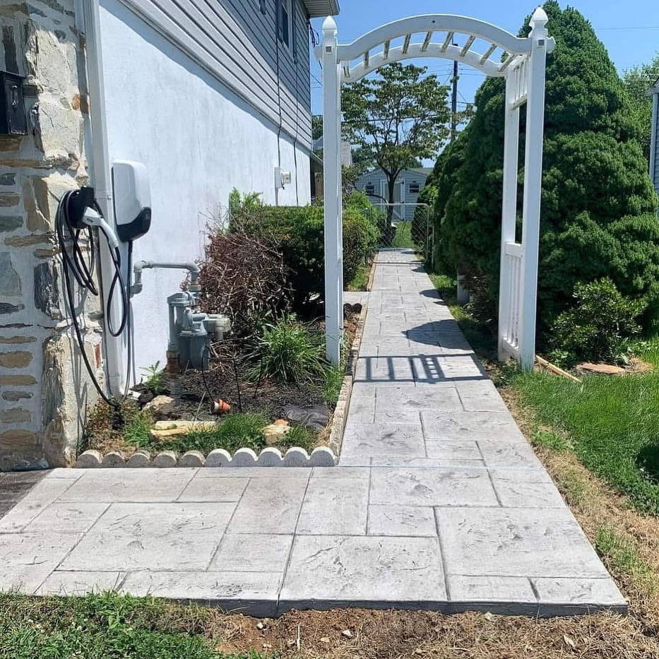 Stamped concrete walkway along the side of a residential home