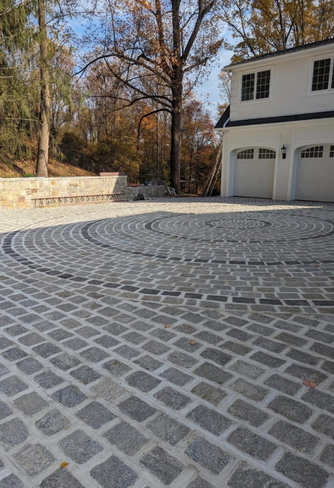 Decorative stamped concrete driveway leading to a residential garage